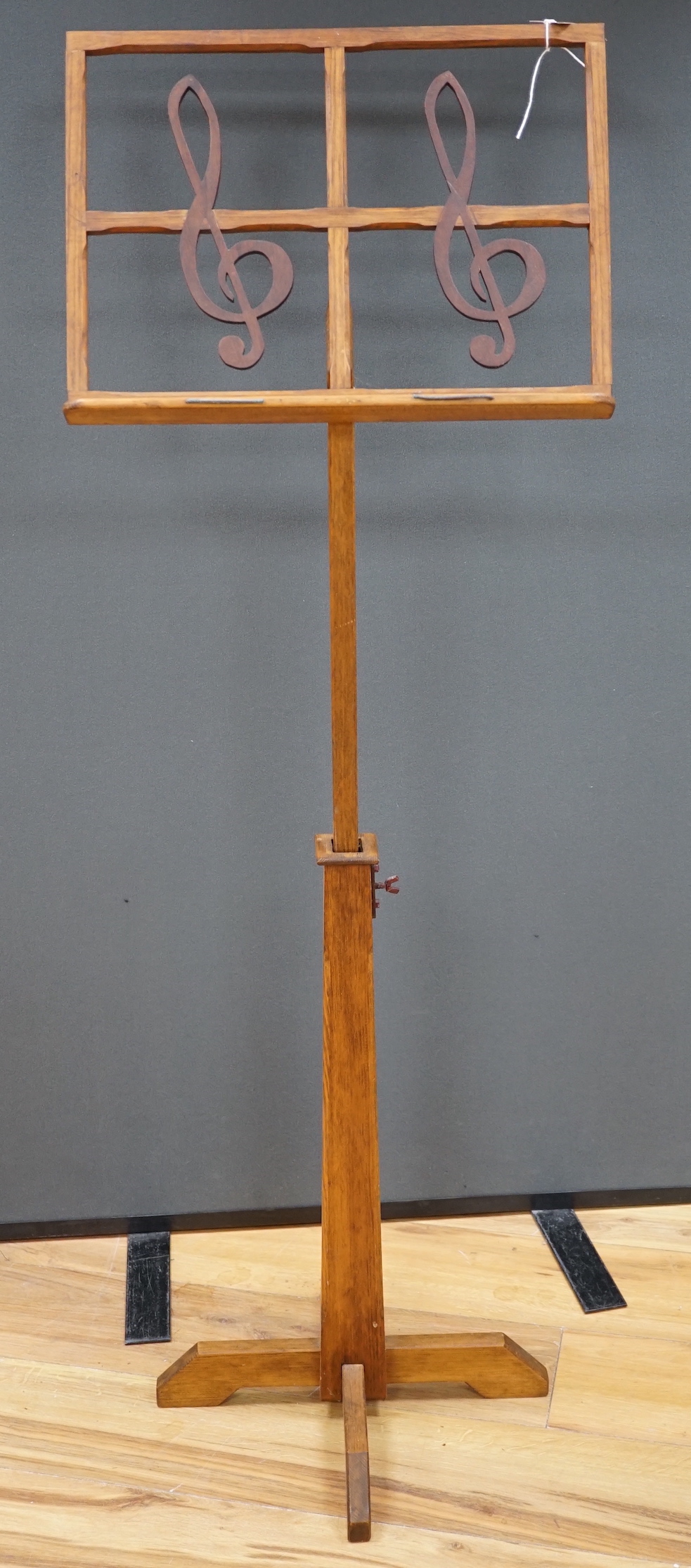 A pine adjustable music stand, with hardwood treble clef decoration